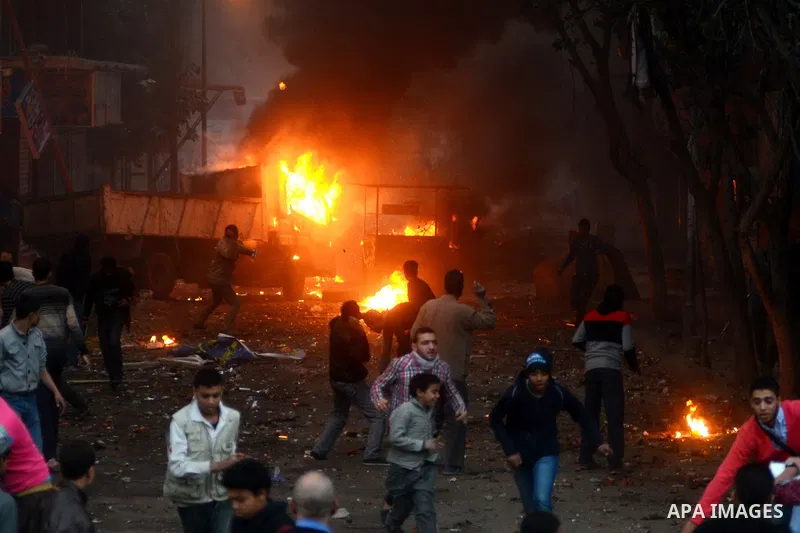 Supporters of the Muslim Brotherhood clash with civilians and Egyptian riot police in Alf Masskan district in the capital Cairo on January 17, 2014. At least one person was killed in clashes between Egyptian police and I...