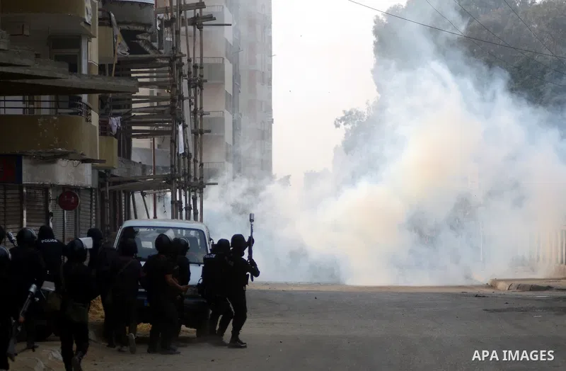 Egyptian riot police take position during clashes with supporters of the Muslim Brotherhood in Alf Masskan district in the capital Cairo on January 17, 2014. At least one person was killed in clashes between Egyptian pol...