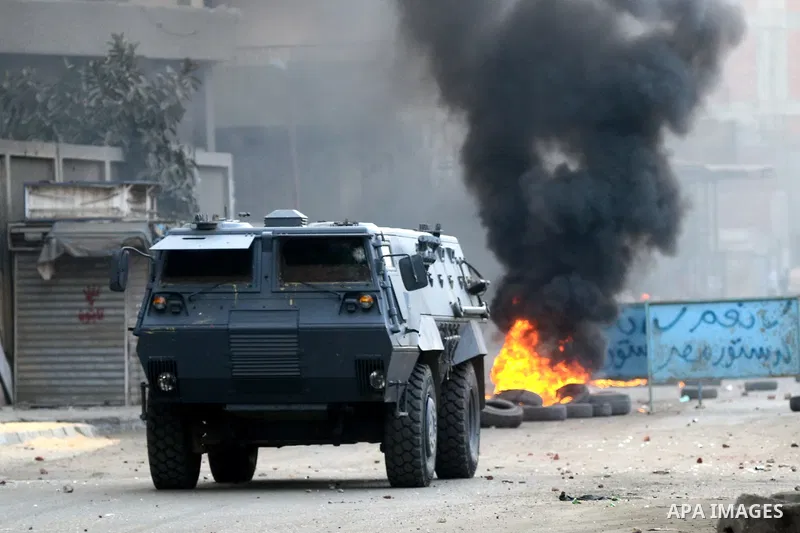 Egyptian riot police take position during clashes with supporters of the Muslim Brotherhood in Alf Masskan district in the capital Cairo on January 17, 2014. At least one person was killed in clashes between Egyptian pol...
