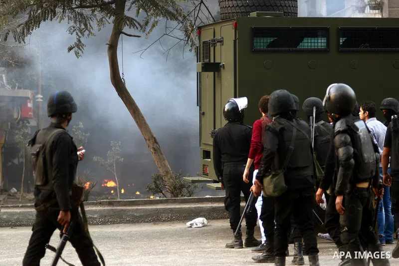 Egyptian riot police take position during clashes with supporters of the Muslim Brotherhood in Alf Masskan district in the capital Cairo on January 17, 2014. At least one person was killed in clashes between Egyptian pol...