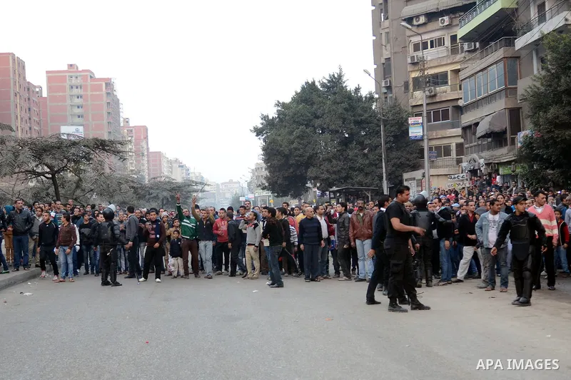 Supporters of the Muslim Brotherhood clash with civilians and Egyptian riot police in Alf Masskan district in the capital Cairo on January 17, 2014. At least one person was killed in clashes between Egyptian police and I...