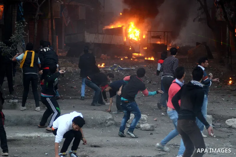 Supporters of the Muslim Brotherhood clash with civilians and Egyptian riot police in Alf Masskan district in the capital Cairo on January 17, 2014. At least one person was killed in clashes between Egyptian police and I...