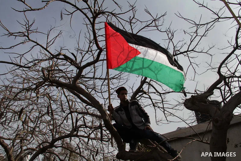 Supporters of the Democratic Front for the Liberation of Palestine take part in a protest to show solidarity with Palestinian refugees in Syria's main refugee camp Yarmouk, in Gaza City on January 19, 2014. Photo by Ashr...
