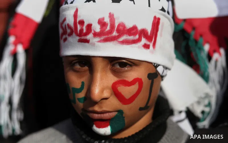 Palestinian children take part in a protest to show solidarity with Palestinian refugees in Syria's main refugee camp Yarmouk, in Gaza City on January 19, 2014. Photo by Ashraf Amra