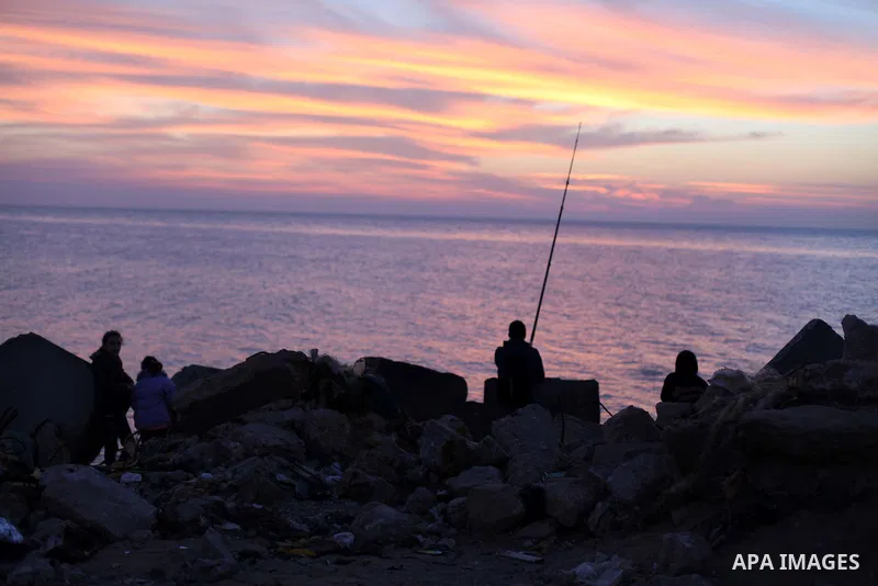 A Palestinian man fishing at Gaza port during the sunset in the west Gaza City January 19, 2013. Earlier on 19 January 2014, Israel launched two more airstrikes in Gaza which caused no injuries. Those were in response to...