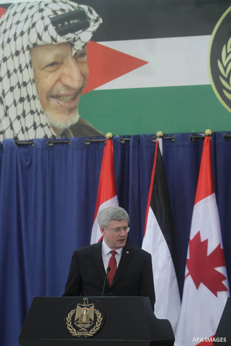 Palestinian President Mahmoud Abbas, right and Canadian Prime Minister Stephen Harper attend a joint press conference at Abbas's headquarters, in the West Bank city of Ramallah, Monday, Jan. 20, 2014. Harper is on a four...