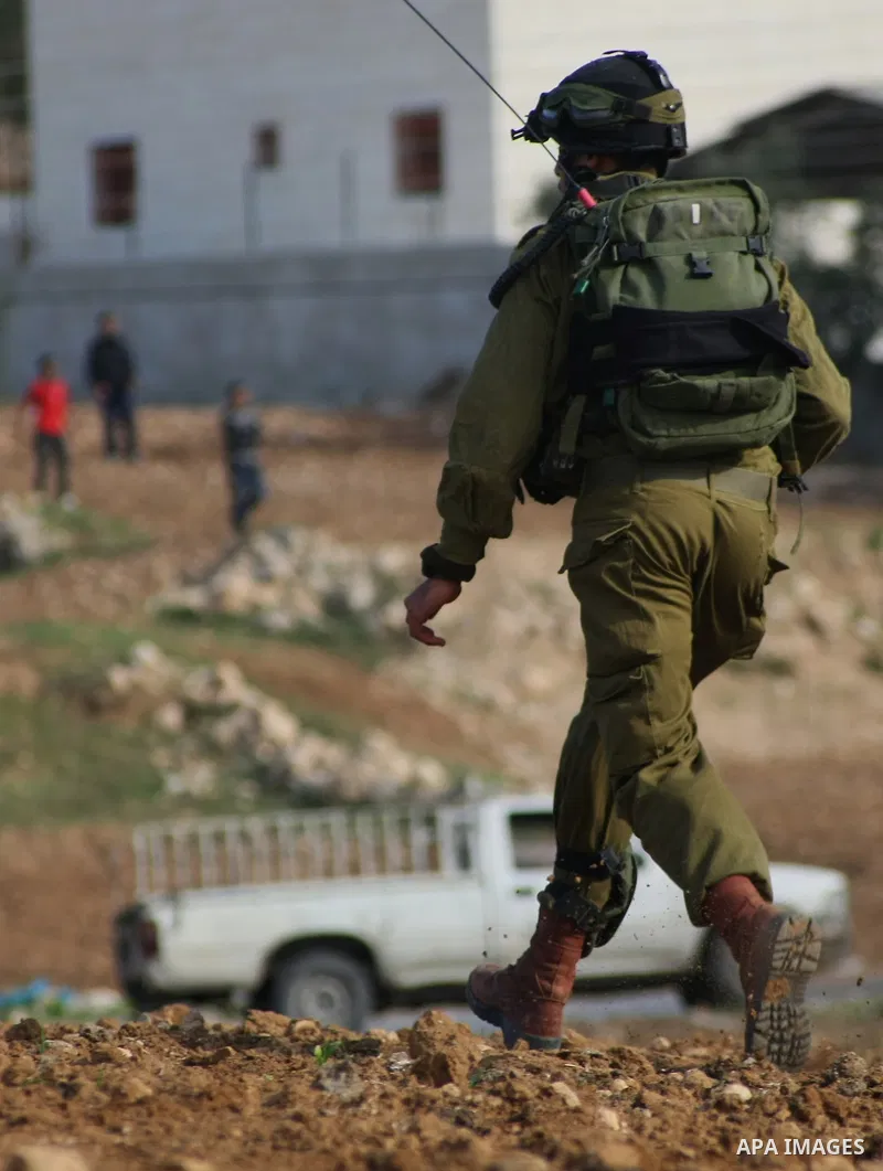 Israeli security forces stand guard during the demolition of a furniture factory which the Israelis said was built without a permit on January 20, 2014 in the village of Deir Samet near the town of Hebron, in the occupie...