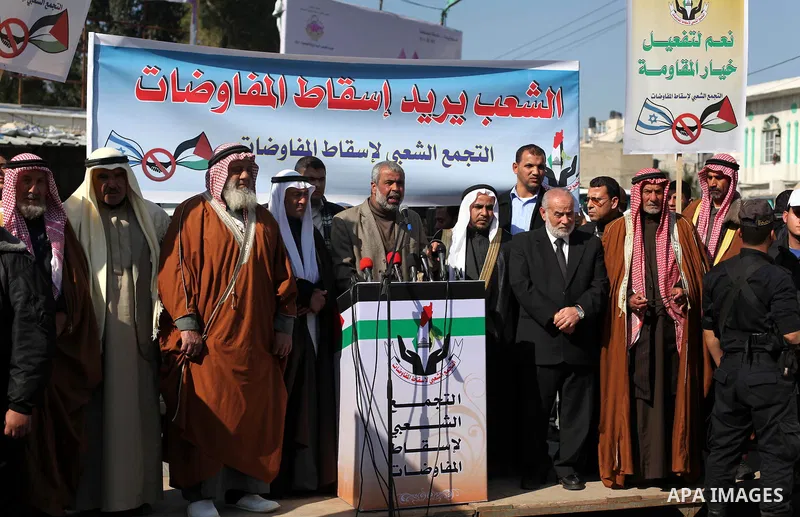 Palestinian protesters hold placards during a demonstration against resuming peace talks with Israel in Gaza City January 20, 2014. Under heavy American pressure, Israel and the Palestinians resumed peace talks after a f...