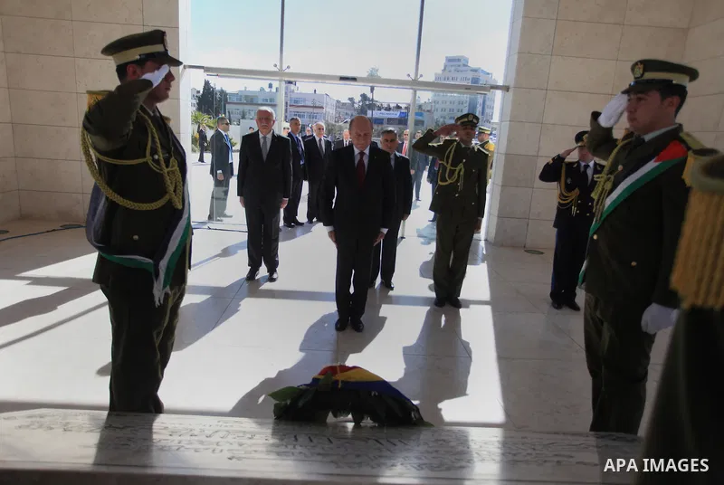 Romanian President Traian Basescu lays a wreath on the tomb of late Palestinian leader Yasser Arafat during a welcome ceremony in the West Bank town of Ramallah on January 21, 2014 before his meeting with Palestinian Aut...