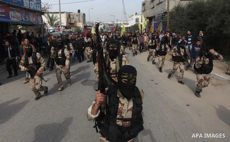 Members the Islamic Jihad Movement take part in the funeral in Beit Hanoun, in the northern Gaza Strip January 22, 2014. Israel killed two Gaza gunmen in an air strike on Wednesday, blaming one of them for firing rockets...