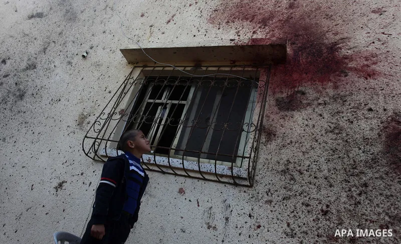 Blood stains are seen on the wall of a house at the site of an Israeli air strike in Beit Hanun, northern Gaza Strip, on January 22, 2014, which killed two Palestinian men including a member of Islamic Jihad militant gro...