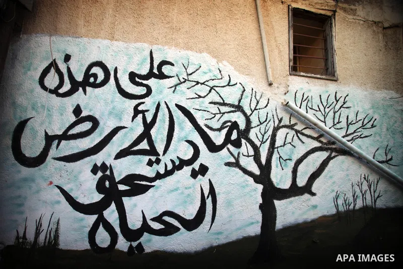 A graffiti is seen reads in Arabic "On this earth what makes life worth living" on a wall in the village of Tarshiha, north Acre on January 21, 2014. Tarshiha was in the territory allotted to the Arab state under the 194...