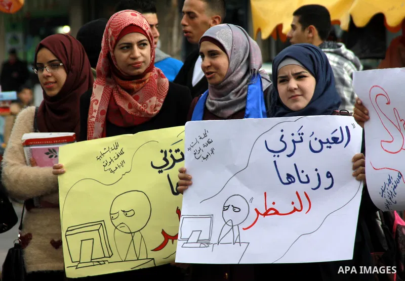 Palestinian students of the al-Najah University take part in a demonstration against the publication of porn movies on the Web sites in the West Bank city of Nablus, on, Jan. 23, 2014. Photo by Nedal Eshtayah