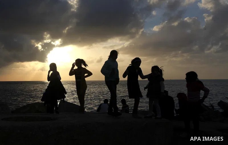 Palestinian children play during the sunset along the seafront in Gaza City, on January 23, 2014. Israeli Prime Minister Benjamin Netanyahu threatened Tuesday to teach Gaza's ruling Hamas movement a lesson "very soon" fo...