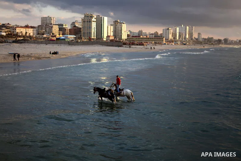 Palestinians ride their horses during the sunset along the seafront in Gaza City, on January 23, 2014. Israeli Prime Minister Benjamin Netanyahu threatened Tuesday to teach Gaza's ruling Hamas movement a lesson "very soo...