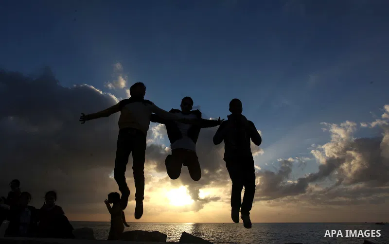 Palestinian children play during the sunset along the seafront in Gaza City, on January 23, 2014. Israeli Prime Minister Benjamin Netanyahu threatened Tuesday to teach Gaza's ruling Hamas movement a lesson "very soon" fo...