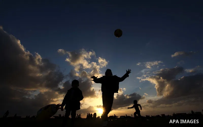 Palestinian children play during the sunset along the seafront in Gaza City, on January 23, 2014. Israeli Prime Minister Benjamin Netanyahu threatened Tuesday to teach Gaza's ruling Hamas movement a lesson "very soon" fo...