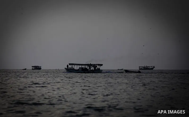 Palestinian fishermen ride their fishing boats during the sunset at the beach of Gaza City, on January 23, 2014. Israeli Prime Minister Benjamin Netanyahu threatened Tuesday to teach Gaza's ruling Hamas movement a lesson...