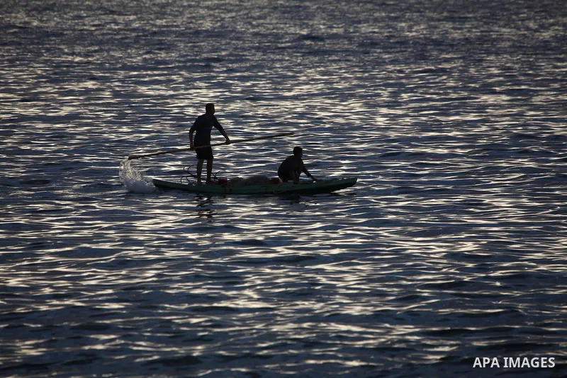 Palestinian fishermen ride their fishing boat during the sunset at the beach of Gaza City, on January 23, 2014. Israeli Prime Minister Benjamin Netanyahu threatened Tuesday to teach Gaza's ruling Hamas movement a lesson...