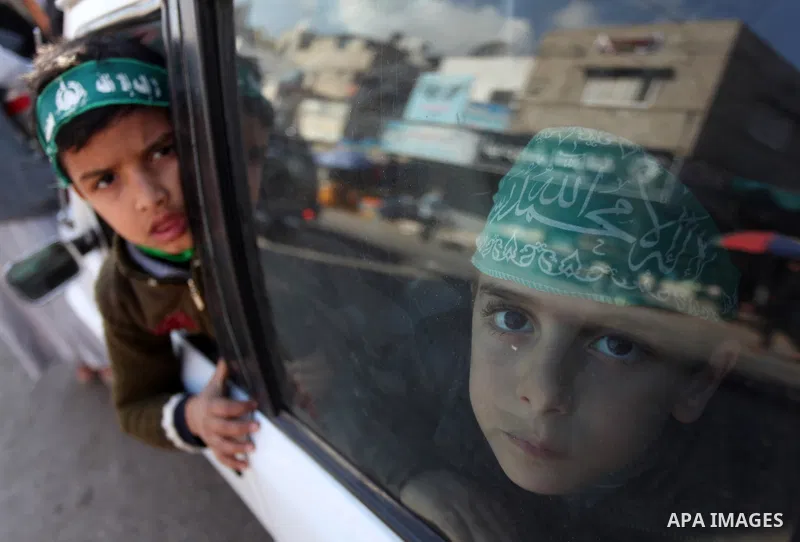 Palestinian supporters of Hamas movement take part in a demonstration in solidarity with Palestinian refugees in the Yarmouk refugee camp in the suburbs of the Syrian capital of Damascus, in Nuseirat camp in central Gaza...