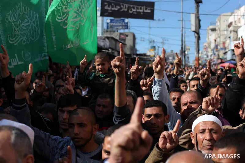 Palestinian supporters of Hamas movement take part in a demonstration in solidarity with Palestinian refugees in the Yarmouk refugee camp in the suburbs of the Syrian capital of Damascus, in Nuseirat camp in central Gaza...