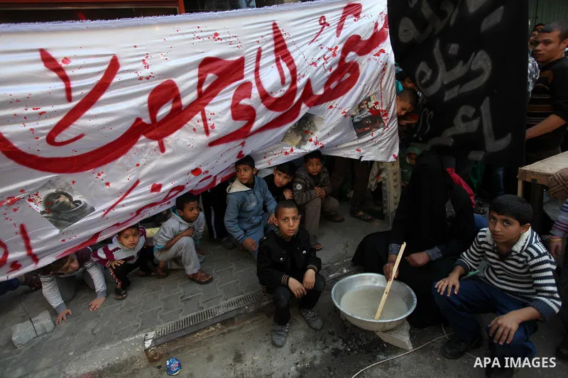 Palestinian supporters of Hamas movement take part in a demonstration in solidarity with Palestinian refugees in the Yarmouk refugee camp in the suburbs of the Syrian capital of Damascus, in Nuseirat camp in central Gaza...