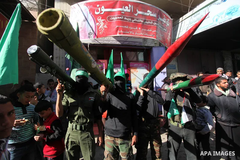 Palestinian supporters of Hamas movement take part in a demonstration in solidarity with Palestinian refugees in the Yarmouk refugee camp in the suburbs of the Syrian capital of Damascus, in Nuseirat camp in central Gaza...