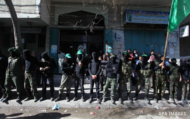 Palestinian supporters of Hamas movement take part in a demonstration in solidarity with Palestinian refugees in the Yarmouk refugee camp in the suburbs of the Syrian capital of Damascus, in Nuseirat camp in central Gaza...