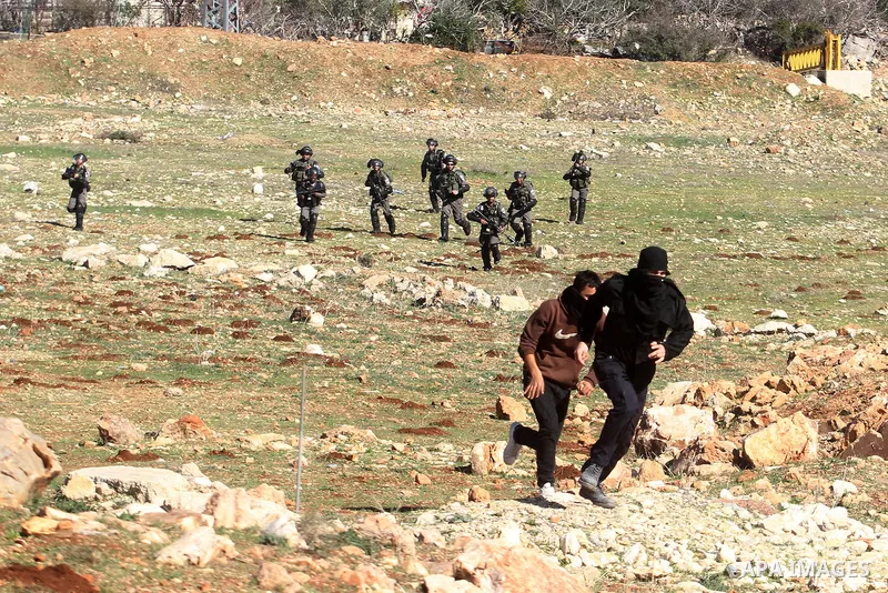 Israeli security forces run after Palestinian stone-throwing protesters during clashes at a protest against Jewish settlements, in the West Bank village of Nabi Saleh, near Ramallah January 24, 2014. Photo by Issam Rimaw...
