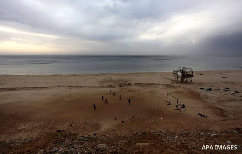 Palestinians play football at the beach of Gaza City on January 27, 2014. Photo by Ashraf Amra