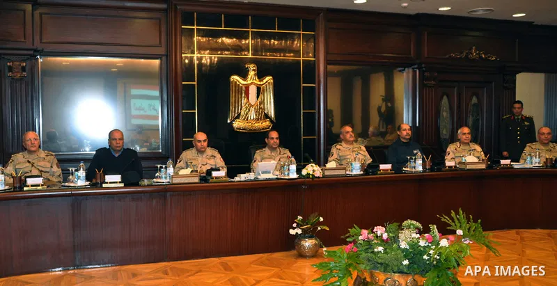 Egypt's army chief Field Marshal Abdel Fattah al-Sisi (C) attends a meeting with Egypt's army chief of staff Lieutenant General Sedki Sobhi at Egypt's military council headquarters in Cairo January 27, 2014. Egypt's top...