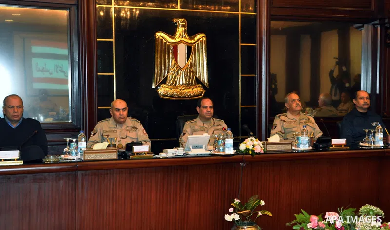 Egypt's army chief Field Marshal Abdel Fattah al-Sisi (C) attends a meeting with Egypt's army chief of staff Lieutenant General Sedki Sobhi at Egypt's military council headquarters in Cairo January 27, 2014. Egypt's top...