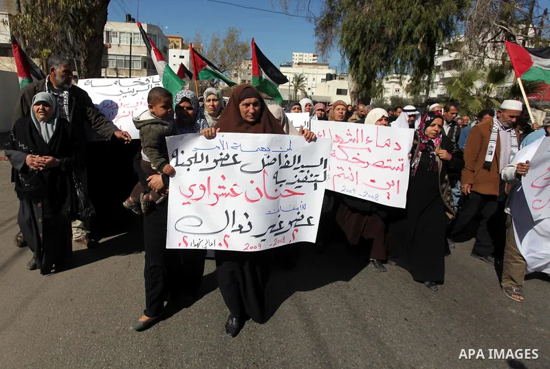 Palestinian families of martyrs who were killed and those that have been wounded in the Israeli-Palestinian conflict in 2008 and 2012, hold placards during a protest against the continued cut of their salaries, in Gaza C...