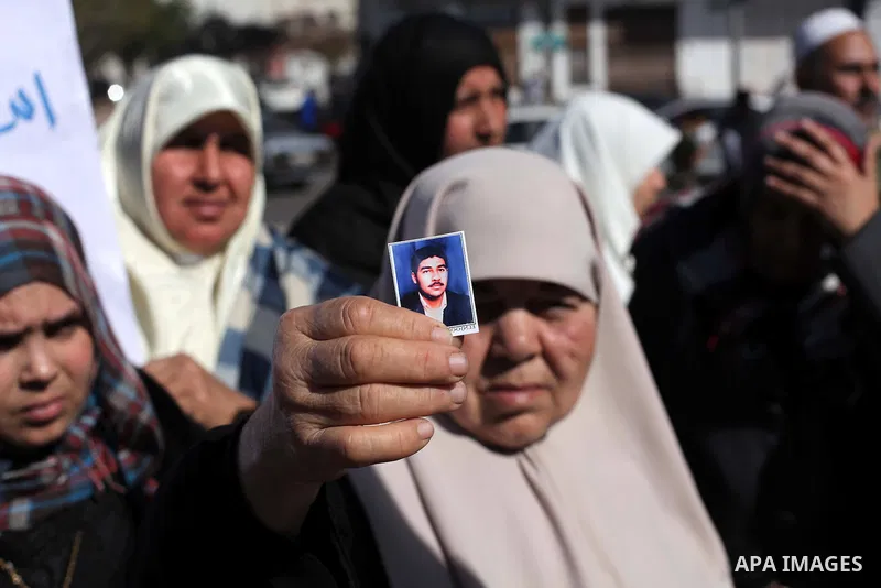 Palestinian families of martyrs who were killed and those that have been wounded in the Israeli-Palestinian conflict in 2008 and 2012, hold placards during a protest against the continued cut of their salaries, in Gaza C...