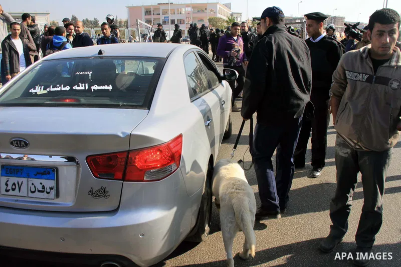 Police and security forces stand guard outside a police academy, where the trial of ousted Egyptian President Mohamed Mursi and members of the Muslim Brotherhood is due to take place, on the outskirts of Cairo, January 2...