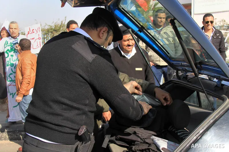 Police and security forces stand guard outside a police academy, where the trial of ousted Egyptian President Mohamed Mursi and members of the Muslim Brotherhood is due to take place, on the outskirts of Cairo, January 2...