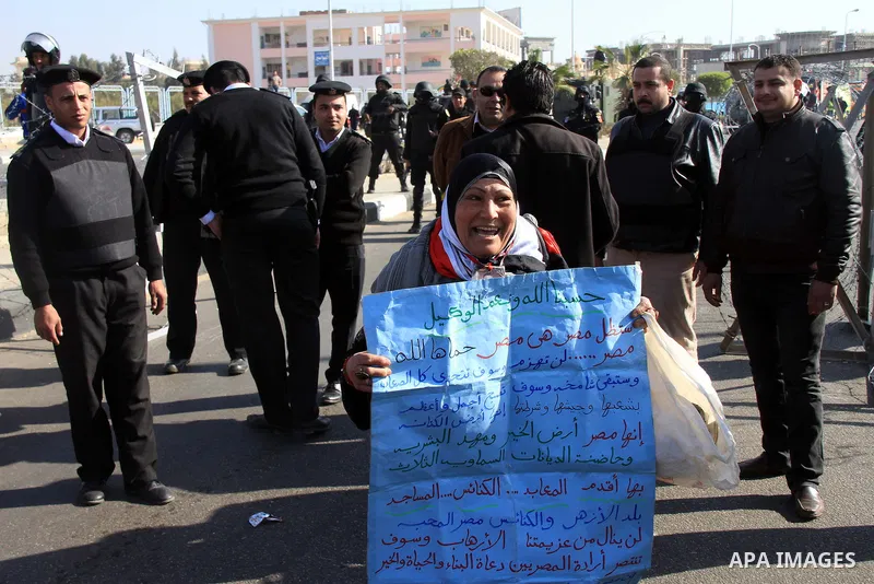 Supporters of Egypt's army chief Field Marshal Abdel Fattah al-Sisi, hold placards during a demonstration outside a police academy on the outskirts of Cairo January 28, 2014, where the trial of ousted Egyptian President...