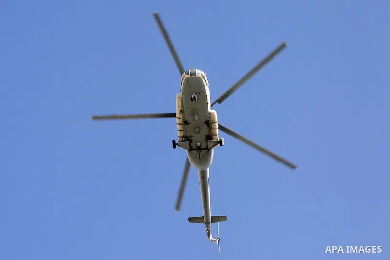An Egyptian army helicopter flies over a police academy, where the trial of ousted Egyptian President Mohamed Mursi and members of the Muslim Brotherhood is due to take place, on the outskirts of Cairo, January 28, 2014....