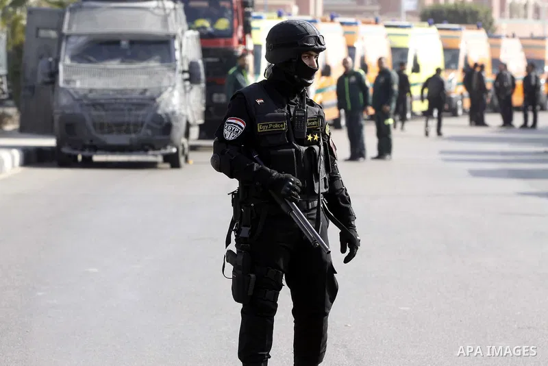 Police and security forces stand guard outside a police academy, where the trial of ousted Egyptian President Mohamed Mursi and members of the Muslim Brotherhood is due to take place, on the outskirts of Cairo, January 2...