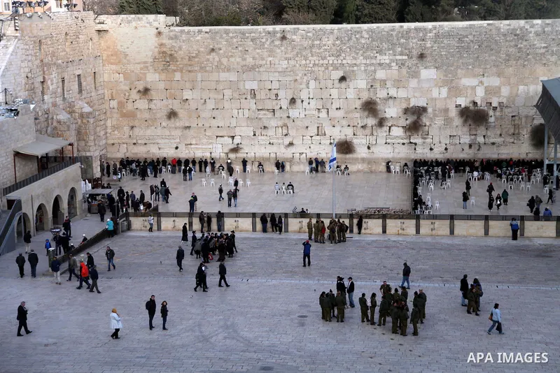 Ultra-Orthodox Jews pray as Israeli workers dig next to the Western wall in Jerusalem's Old City on January 28, 2014. The Al-Aqsa Foundation for Religious Endowments and Heritage said that Israeli authorities had begun n...