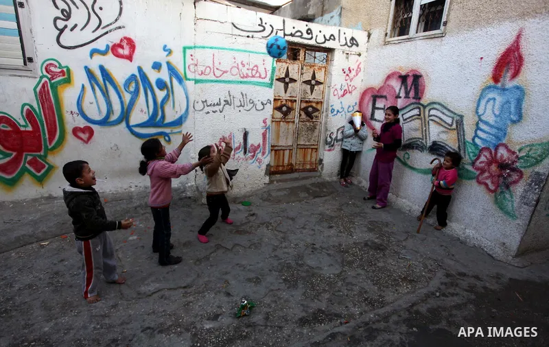 Palestinian children play outside their families' houses at al-Shati refugee camp in the west Gaza City January 29, 2014. Photo by Ashraf Amra