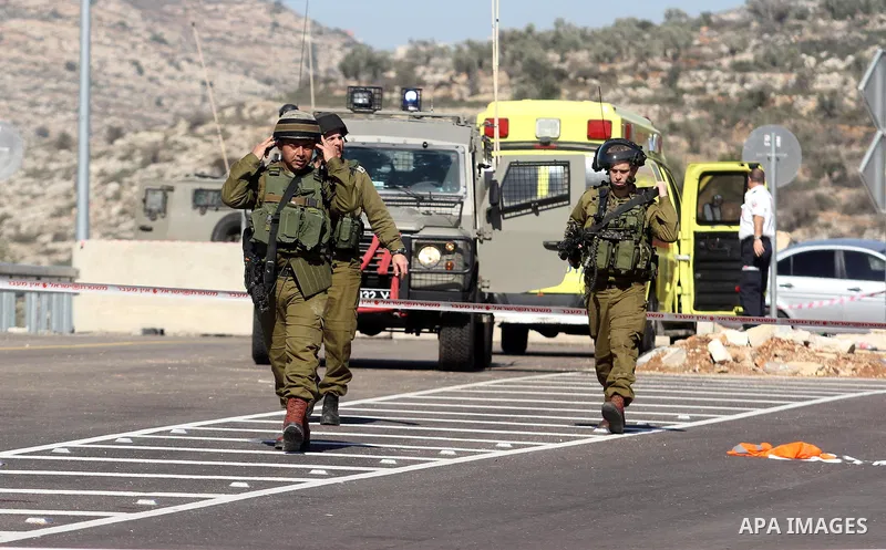 Israeli soldiers stand guard near the site of a fatal shooting incident next to the Palestinian village of Ein Sariya, north of the West Bank city of Ramallah January 29, 2014. Israeli soldiers killed Muhammad Mubarak, 2...