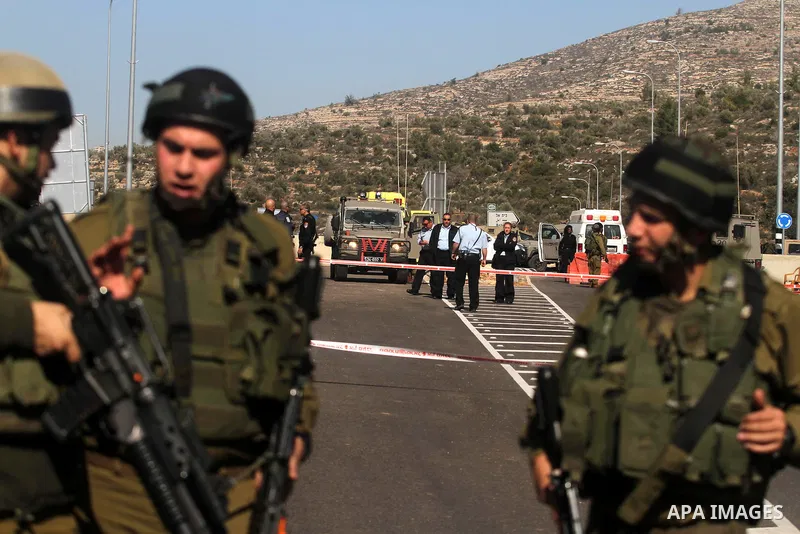 Israeli soldiers stand guard near the site of a fatal shooting incident next to the Palestinian village of Ein Sariya, north of the West Bank city of Ramallah January 29, 2014. Israeli soldiers killed Muhammad Mubarak, 2...