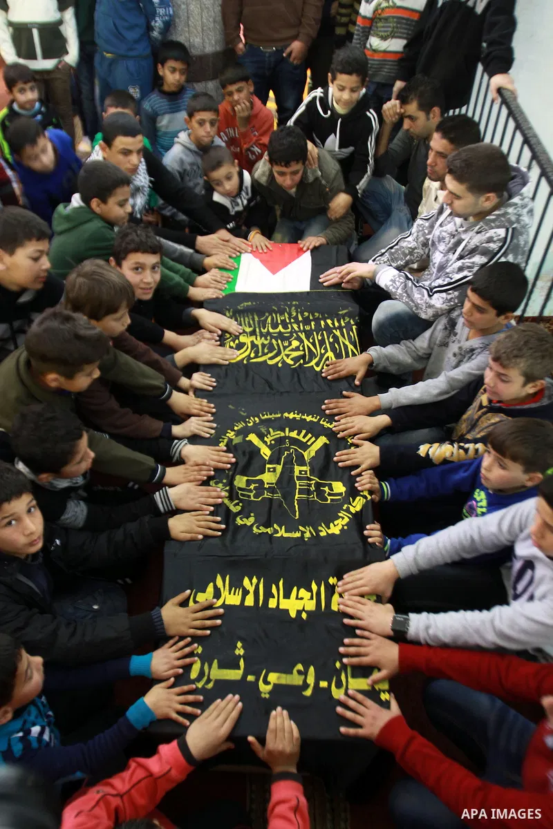 Palestinian children gather around the coffin of Abdulkareem Tahaina killed in 2002 by Israeli Army after his remains were returned in West Bank city of Jenin on Jan. 29 2014. Israel planed to return the bodies of 36 Pal...