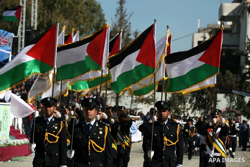 Palestinian policemen loyal to Hamas march during a graduation ceremony in Gaza City January 29, 2014. Photo by Ashraf Amra