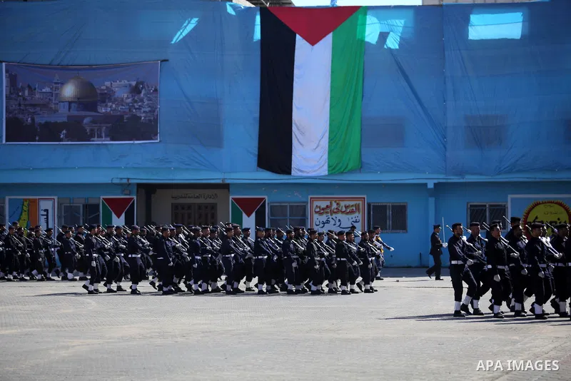 Palestinian policemen loyal to Hamas march during a graduation ceremony in Gaza City January 29, 2014. Photo by Ashraf Amra