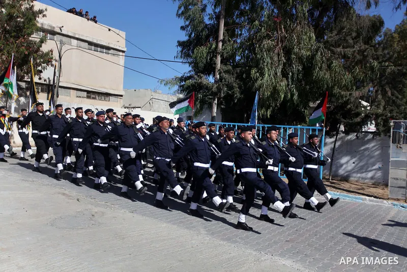 Palestinian policemen loyal to Hamas march during a graduation ceremony in Gaza City January 29, 2014. Photo by Ashraf Amra