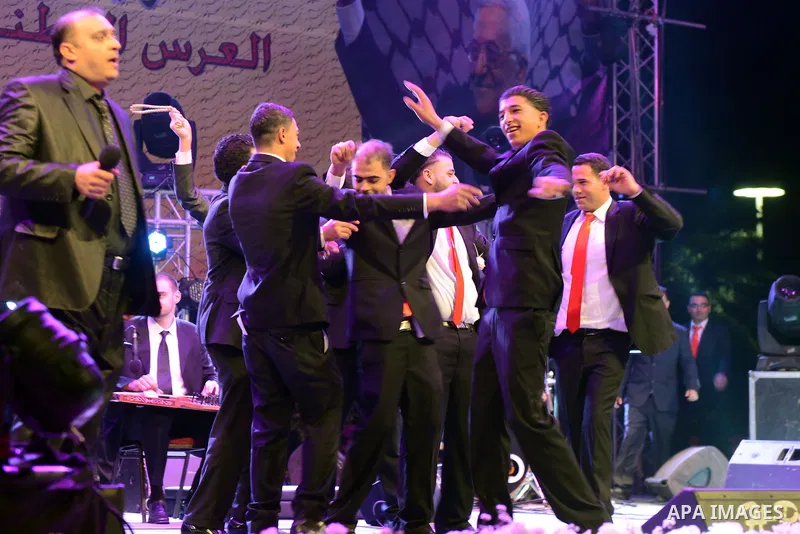 Palestinian grooms dance during a mass wedding ceremony attended by Palestinian Authority President Mahmud Abbas (unseen) in the West bank city of Jericho. Nearly 300 Palestinians were married in the West Bank and the Ga...