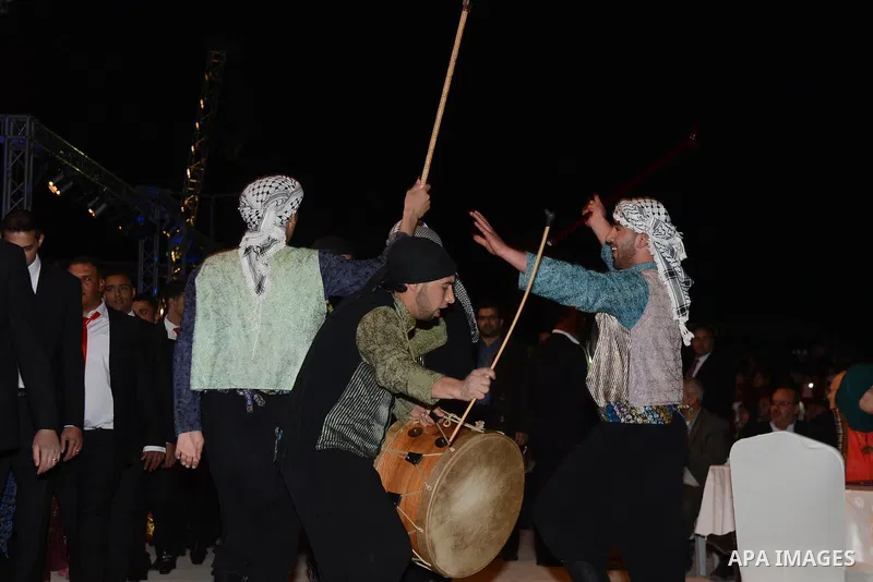 Palestinians dance during a mass wedding ceremony attended by Palestinian Authority President Mahmud Abbas (unseen) in the West bank city of Jericho. Nearly 300 Palestinians were married in the West Bank and the Gaza Str...