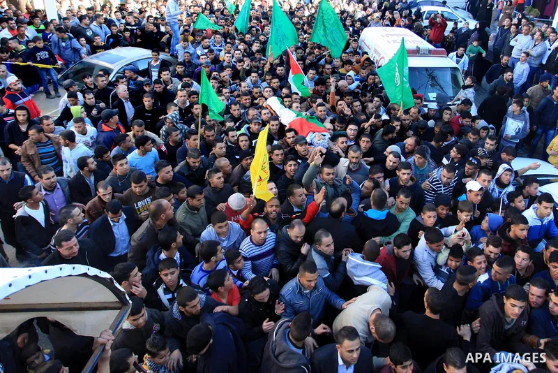Palestinians carry the body of Mohammad Mubarak, 18, during his funeral at the Jalazoun refugee camp near the West Bank city of Ramallah, Wednesday, Jan. 29, 2014. Israeli troops shot Mubarak to death on Wednesday in an...